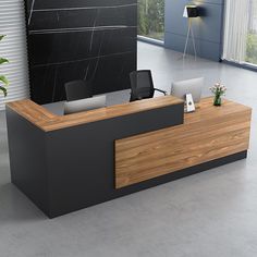 an office desk with two laptops on it in front of a black wall and large windows