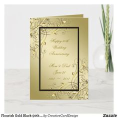 a wedding anniversary card with gold foil and flowers in a vase on a marble surface