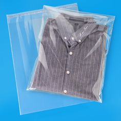 a shirt in a plastic bag on a blue background