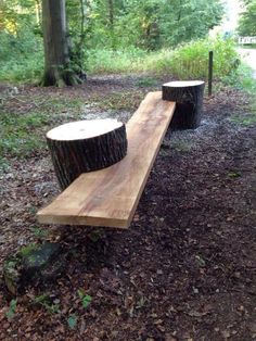 two wooden benches sitting in the middle of a forest