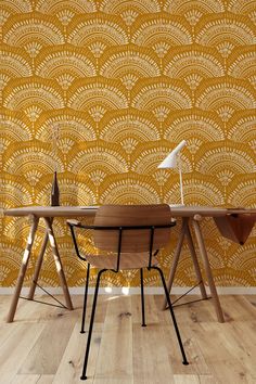 a wooden table sitting in front of a yellow wallpapered room with a lamp on top of it