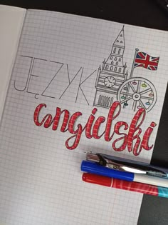 two pens are sitting on top of a notebook with the word canada written in it