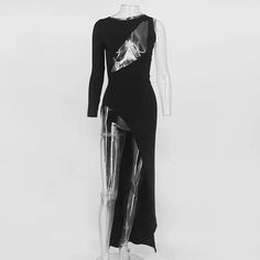 a black and white photo of a mannequin wearing a dress with metallic details