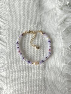 FOR OTHER DAINTY BEADED BRACELETS: https://www.etsy.com/ca/shop/ArtiChouXCanada?ref=seller-platform-mcnav§ion_id=46088511 Bracelet Length: 13-18cm (5.1-7 inches) with a 14k gold filled extender.  This bracelet features an assortment of mysterious purple toned colors: purple, violet, white, and 18k gold filled seed beads. It also contains a freshwater pearl.  Thread may be visible since it is a handmade product   SIZING  Wrap a soft measuring tape snugly around the widest part of your wrist. Add 1.27cm (0.5in) to that measurement to determine the right bracelet size.  MATERIALS  - Japanese MGB glass seed beads(2x4mm) - 18K gold filled beads of 2mm - Freshwater pearl - 14K gold filled extender  CARE INSTRUCTIONS   To maintain its radiance, gently clean the bracelet with a soft cloth and stor Purple Seed Bead Bracelet, Seed Bead Bracelet, Colors Purple, Freshwater Pearl Bracelet, Purple Violet, Beaded Accessories, Jewelry Boho, Seed Bead Bracelets, Measuring Tape