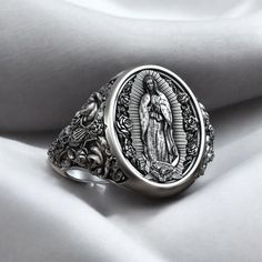 Honor the grace and protection of the Lady of Guadalupe with this stunning Cross Roses Virgin Mary Catholic Ring, crafted from high-quality 925 Sterling Silver. This elegant ring features a detailed depiction of the Virgin Mary surrounded by crosses and roses, representing love, devotion, and divine grace. Each piece is meticulously handmade to capture the intricate floral patterns and sacred motifs, ensuring a unique and meaningful piece of religious jewelry. Perfect for both men and women, thi Catholic Ring, Mary Catholic, Divine Grace, Viking Ring, Masonic Ring, Retro Ring, Lady Of Guadalupe, Animal Rings, Everyday Rings