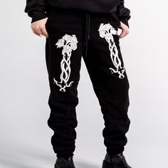 Unisex "Jogger" Style Sweatpants from Forbidden Alchemy. Designed for both comfort and style, these slim-fitting joggers feature a tapered ankle for a sleek silhouette that flatters all body types. Crafted from a premium blend of 80% cotton and 20% polyester, they offer the perfect balance of softness and durability, ensuring all-day comfort and long-lasting wear. Slim Fit: Tailored to hug your body while allowing ease of movement. Tapered Ankle: Provides a modern, streamlined look. Premium Fabr Stretch Sweatpants With Elastic Waistband For Streetwear, Fitted Tapered Leg Streetwear Joggers, Stretch Straight Pants For Streetwear, Sporty Fitted Pants For Streetwear, Streetwear Joggers With Comfort Waistband And Tapered Leg, Urban Jogging Pants, Baggy Straight Joggers For Streetwear, Urban Stretch Sweatpants For Loungewear, Fitted Tapered Leg Streetwear Bottoms