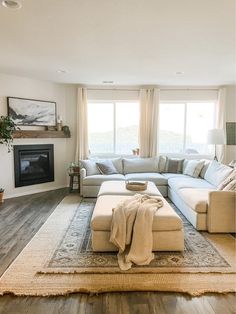 a living room filled with furniture and a fire place under a window next to a fireplace