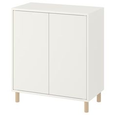 a white cabinet with two doors and wooden legs