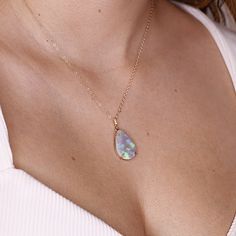 "Pear cabochon shaped beautiful Ethiopian opal pendant necklace. It's featured on 14k yellow solid gold handmade prong setting, diamond bail and 14k yellow solid gold chain. Opal is oval shaped cab cut and unique. DETAILS  Pendant size : 21.5mm height, 14.5mm width Bails has 3 diamonds total 0.01 ct.  It's coming with 16' to 18\" adjustable 14k solid gold chain.  all our raw materials are sourced from US-based companies for the quality and safety of our handmade products.  this necklace is handc Fine Jewelry With Cabochon Drop, Fine Jewelry Drop Cabochon, Gold Cabochon Teardrop Pendant, Gold Cabochon Teardrop Pendant Jewelry, Iridescent Fine Jewelry As A Gift, Fine Jewelry Iridescent Gemstone, Fine Jewelry Opal Birthstone, Fine Gold Opal Jewelry, Gold Opal Fine Jewelry