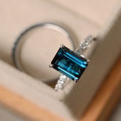 This ring features a 7*9mm emerald cut London blue topaz and sterling silver finished with rhodium. Customization is available. It is made by hand, and it will take about 7 days to finish the ring after your payment is completed. Main stone: London blue topaz London blue topaz weight: Approx 3.15 ct Metal type: sterling silver finished with rhodium Accent stone: cz Customization is available, I also can make it with 14k solid gold (white or yellow or rose) and diamond accent stone, just feel fre London Blue Topaz Engagement Rings, November Birthstone Ring, Blue Topaz Engagement Ring, Topaz Engagement Ring, London Blue Topaz Ring, Ring Blue, Silver Engagement Rings, Emerald Engagement Ring, Unique Engagement