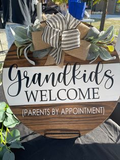 a wooden sign that says grandkids welcome parents by appointment on the front porch