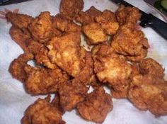 some fried food sitting on top of a paper towel next to a knife and fork