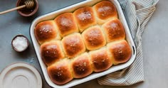 a baking dish filled with hot cross buns on top of a blue table cloth