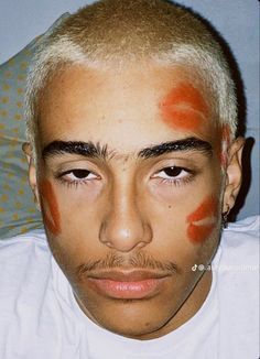 a man with orange paint on his face