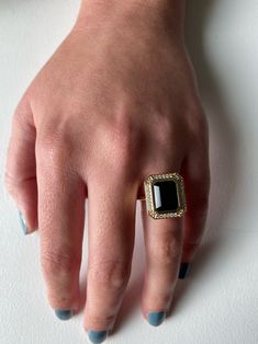 The vintage-inspired cocktail ring of our dreams! A 2.9ct emerald cut Onyx is bezel-set and surrounded by a .11tcw SI white Diamond halo. Perfect balance of metal-forward and hauntingly romantic. #onyx #statementring Luxury Evening Rings With Gemstone, Modern Open Crystal Ring For Formal Occasions, Elegant Gemstone Signet Ring For Formal Occasions, Elegant Evening Rings With Center Stone, Luxury Crystal Open Ring, Luxury Open Crystal Ring, Formal Open Diamond Ring, Luxury Formal Jewelry With Center Stone, Evening Diamond Ring Jewelry