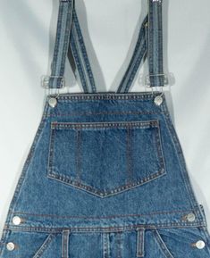 Here's a pair of classic made in U.S.A. 1980's Bongo label overalls jeans cutoff shorts that have a cool painter cut. You will love wearing this comfy pair of great collectible shorts overalls cutoffs for your artful, tinkering and green thumb ways. These casual Bongo dungarees have a relaxed style that are on trend in look and they are comfortable, with pockets, metal buttons and logo patch. These retro shortalls are original overalls cut offs and the denim is of really great vintage quality. T Cotton Cutoff Shortalls With Pockets, Retro Bottoms Overalls With Pockets, Denim Blue Retro Overalls, Retro Denim Blue Overalls, Retro Dark Wash Shortalls With Pockets, Vintage Bib Front Medium Wash Bottoms, Vintage Medium Wash Bib Front Bottoms, Vintage Dark Wash Shortalls With Pockets, Vintage High-waist Overalls With Pockets