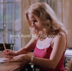 a woman sitting at a table writing on a piece of paper with the words work hard like ellen woods