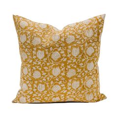 a yellow and white pillow on a white background