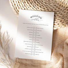 a white sheet of paper sitting on top of a table next to a straw hat