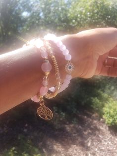 This stack includes a bracelet designed with icy pink beads and a cute evil eye charm, a bracelet designed with icy clear gold and dark gold beads, and a bracelet with pink beads along with The Tree of Life charm. Cute Evil, Icy Pink, Stacked Bracelets, Bracelets Design, The Tree Of Life, Dark Gold, Evil Eye Charm, Pink Beads, Bracelet Stack