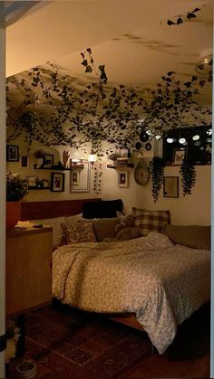 a bed room with a neatly made bed and lots of pictures on the wall above it