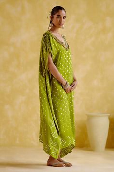 Green kaftan with bandhani print, ghungroo embroidered V neckline and flared sleeves.
Components: 1
Pattern: Printed, Embroidered
Type Of Work: Bandhani, Ghungroo
Neckline: V Neck
Sleeve Type: Flared Sleeves
Fabric: Modal satin lagdi patta
Color: Green
Other Details: 
Length : Approx 54 inches, Lengths may vary as per size and height
Occasion: Sangeet - Aza Fashions Bandhani Pattern, Green Kaftan, Bandhani Print, Kaftan For Women, Types Of Work, Flared Sleeves, Aza Fashion, Sleeve Type, Types Of Sleeves