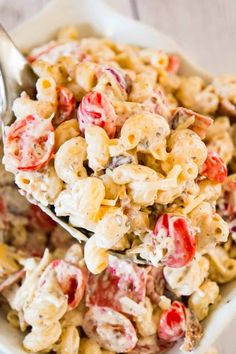 a white bowl filled with pasta salad and a spoon