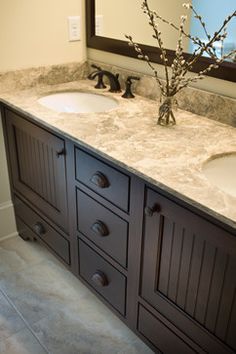 a bathroom with two sinks and a large mirror