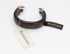 Ralph Lauren Crocodile Sterling Bracelet Limited edition RL cuff bracelet with brown genuine crocodile leather and sterling silver ends. Approximate Measurements: Diameter 2.3”, Opening 1”, Width 0.8” Size: best suited for a small wrist Made in: USA Condition: Brand new with tags. In very good condition Brown Cuff Bracelets For Formal Occasions, Formal Brown Leather Bracelet, Luxury Brown Cuff Bracelet As Gift, Luxury Brown Bangle Bracelet, Formal Brown Cuff Bracelet Bangle, Luxury Brown Adjustable Cuff Bracelet, Formal Brown Leather Cuff Bracelet, Genuine Love, Sterling Bracelets