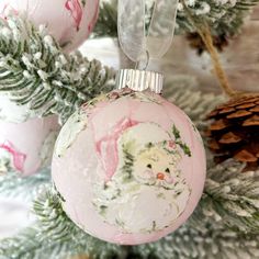 a pink ornament hanging from a christmas tree