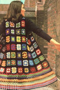 the woman is wearing a multicolored crocheted dress