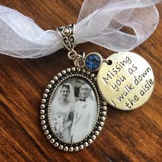 a necklace with an image of two people on it and the words missing you sown