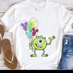 a t - shirt with an image of a cartoon character holding balloons on the chest