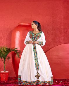 The Habesha dress, also known as the Habesha Kemis, is a quintessential representation of Ethiopian traditional dress, showcasing intricate patterns and vibrant colors. These elegant garments are often adorned with delicate embroidery and unique, hand-woven designs, making each piece a true work of art. The intricate p Eid Long Sleeve Dresses With Woven Motifs, Festive Anarkali Dress With Woven Motifs, Cotton Dress With Resham Embroidery For Eid, Anarkali Dress With Woven Motifs For Traditional Ceremonies, Traditional Festive Dress With Woven Motifs, Navratri Dresses With Woven Motifs, Festival Maxi Dress With Resham Embroidery For Traditional Ceremonies, Transitional Festive Dresses With Woven Motifs, Festive Long Sleeve Dress With Woven Motifs