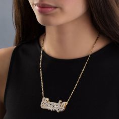 Eye-catching and bold, this personalized diamond accent hammered name plate necklace with heart ribbon displays your unique taste in fashion. Crafted in sterling silver and 24K gold plate This three-dimensional design spells out your name - from three to 10 characters in length - in a silver hammered script font. A similarly textured heart and ribbons are beautifully set beneath the name, while a polished 24K gold-plated silver plate adds dimension and contrast. This look suspends centered along Nameplate Necklace Gold, Name Plate Necklace, Heart Ribbon, Diamond Cufflink, Necklace Name, Gold Pendants, Bamboo Earrings, Money Clips, Nameplate Necklace