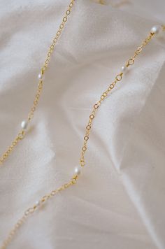 An effortless piece that's perfect for everything. Pearls are believed to be a calming, centering gem that nourishes integrity, faith, and loyalty. They are also symbols of femininity, helping one connect with their inner goddess or feminine energy.This necklace features alternating small and medium pearls that are hand-set onto a shimmering chain. The pearls are slightly irregular in shape and may contain natural natural grooves. Chains are available in sterling silver or 14k gold filled.PEARL Graceful Pearl Chain Jewelry Gift, Tarnish Resistant 14k Gold Filled Necklace For Wedding, Graceful Gold Necklace With Pearl Charm, Gold Pearl Necklace As A Gift For Her, Graceful Gold Necklace With Pearl Chain, Graceful Gold Pearl Chain Jewelry, Dainty Tarnish-resistant Pearl Jewelry, Gold Necklaces With Pearl Drop As Gift For Her, Gold Necklace With Pearl Drop As Gift For Her