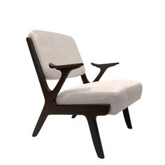 an upholstered chair with black legs and a white fabric seat pad on the back