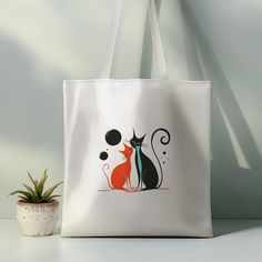 Add a touch of romance to your daily routine with our "Romantic Cat Couple Satin Tote Bag." This artistic and stylish tote bag features a striking design of two elegant cats in love, accentuated with bold colors and modern lines. The unique artwork adds a sense of charm and sophistication to any outfit, making it perfect for everyday use. * Material: 100% polyester, luxury satin white, making it strong and durable for everyday use. * Size: Measures 38cm W x 40cm H, 75cm H with handle, offering a White Bag With Cat Design As A Gift, White Bag With Cat Design For Gift, White Bags With Cat Design For Gift, White Cat Design Bag As A Gift, White Cat Design Bag As Gift, White Shoulder Bag With Cat Design As Gift, White Shoulder Bag With Cat Design For Gift, Rectangular Shoulder Bag With Cat Design For Gift, White Cat Design Shoulder Bag For Gift