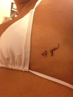 a woman's stomach with the word love written in cursive writing on it