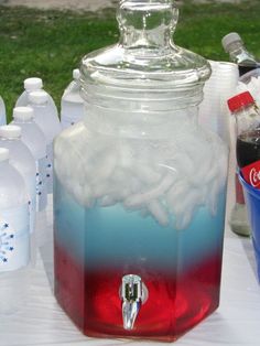 there is a large jar with soda in it on the table