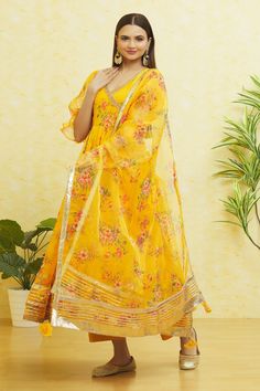 Saffron yellow floral print anarkali with balloon sleeves and side tie-up. Paired with a matching pant and dupatta.
Components: 3
Pattern: Embroidered
Type Of Work: Gota
Neckline: V Neck
Sleeve Type: Balloon
Fabric: Organza
Color: Yellow
Other Details: 
Balloon sleeves
Side tie-up
Closure: 
Pant: Front drawstring tie-up

Occasion: Mehendi and Haldi - Aza Fashions Yellow Palazzo Set With Printed Motifs In Traditional Drape, Traditional Yellow Palazzo Set With Printed Motifs, Yellow Palazzo Set With Printed Motifs And Traditional Drape, Yellow Palazzo Set With Printed Motifs For Navratri, Yellow Sharara With Printed Motifs For Navratri, Navratri Yellow Palazzo Set With Printed Motifs, Designer Yellow Kurta With Printed Motifs, Designer Wear Yellow Kurta With Printed Motifs, Yellow Chanderi Palazzo Set With Printed Motifs