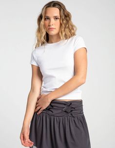 Tilly's Crew Tee. Solid Tee. Rib Knit Construction. Crew Neckline. Short Sleeve. Fitted Silhouette. 60% Cotton, 35% Polyester, 5% Spandex. Machine Wash. Imported. Model Is Wearing A Size Small. Model Measurements:height: 5'9" Bust: 32"waist: 25"hips: 35" | Tillys Crew Tee Casual Seamless Elastane Top, Seamless Fitted Casual T-shirt, Fitted Short Sleeve Basic Knit Top, Basic Fitted Short Sleeve Knit Top, Fitted Short Sleeve Knit Top, Casual Short Sleeve Top For Summer, Basic Stretch Cotton Knit Top, Basic Cotton Stretch Knit Top, Casual Short Sleeve Summer Top