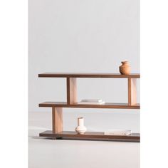 two wooden shelves with vases on each shelf