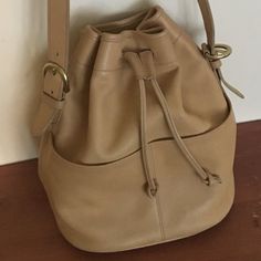 Authentic Coach Leather Bag In Great Used Condition No Rips Or Surface Damage Scratches To The Leather, Some Discoloration On The Bottom (See Pics) Adjustable Strap So It Can Be Worn Longer Or Shorter Crossbody Or Shoulder Bag Classic Drawstring Bucket Style With 2 Front Pockets Inner Zipper Pocket Approx. Dims: 10.5" Wide At Middle, 11" At Top (Extended), 8.75" Wide On Bottom Base 11.25" High 5.25" Deep 17.5 - 19.5" Adjustable Drop (Shoulder To Bag Top) Coach Beige Leather Hobo Bag, Coach Leather Bucket Bag With Removable Pouch, Coach Everyday Bucket Satchel, Coach Beige Bucket Bag, Coach Bucket Satchel For Everyday, Coach Bucket Bag With Removable Pouch For Everyday, Classic Coach Bucket Bag For Everyday Use, Coach Leather Bucket Hobo Bag, Coach Leather Satchel Bucket Bag