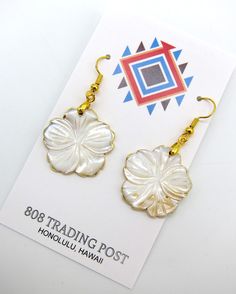 "Genuine Gold Lip Mother of Pearl Hawaiian Style Flower Style Earrings with Gold Plating Hand Made with Stainless Ear Wires Free Shipping.  Vivid colors with some beautiful variations that are natural for the Gold Lip shell used to culture Tahitian Gold south sea pearls.  Earrings are over 1\" in diameter with a drop about 2 inches off the ear.  Accented with gold plating on the edges. Stainless steel ear wires for your safety.  Ships for FREE direct to your home or office." Elegant Flower Shaped Earrings For Beach, Elegant Flower-shaped Earrings For Beach, Gold Flower-shaped Earrings For Beach, Gold Flower Earrings For Beach, White Flower Shaped Jewelry For Beach, South Sea Pearls Earrings, Gold Lips, Pearls Earrings, Flower Style