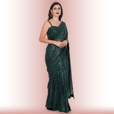 Introducing the exquisite "1 Minute Sequin Saree - Iridium"! ✨ Crafted from luxurious georgette, this saree combines timeless elegance with modern convenience. Designed for the busy fashionista, it comes pre-stitched for hassle-free draping. The dazzling iridium sequins glisten with every step, ensuring you steal the spotlight wherever you go. 💃Complementing this beauty is a classy spaghetti strap blouse that adds a touch of sophistication and allure to your ensemble. ✨Ideal for weddings, parti Glamorous Festive Pre-draped Saree For Celebration, Bollywood Style Formal Saree With Mirror Work, Formal Bollywood Saree With Mirror Work, Traditional Georgette Pre-draped Saree For Celebration, Pre-draped Georgette Saree For Celebration, Formal Diwali Saree With Mirror Work, Formal Semi-stitched Saree With Mirror Work, Formal Floor-length Pre-draped Saree For Diwali, Formal Georgette Saree With Mirror Work