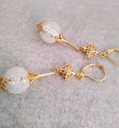 Sleek sellouts! 🤓. Order White bead ball earrings 24 k gold filling Ethnic style beaded at €75.0 #EthnicStyle #MosaicEarrings #WickerJewelry #ChandelierEarrings #SeedBeadMaking #GoldFilling #MosaicMaking #FolkloreJewelry #24kGold #BeadedEarrings Traditional Gold Earrings With Faceted Beads, Elegant Round Beaded Earrings With Faceted Beads, Festive Elegant Round Beaded Earrings, Elegant Gold Beaded Earrings With Faceted Beads, Elegant White Earrings With Faceted Beads, Elegant White Earrings With Gold Beads, Romantic Style Outfit, Mosaic Earrings, Bead Ball