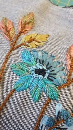 an embroidered piece of cloth with flowers on it