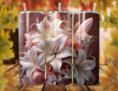 three vases with flowers in them sitting on a wooden table next to autumn leaves