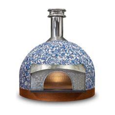 an outdoor pizza oven with blue and white mosaic tiles on the outside, in front of a white background